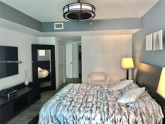 bedroom featuring wood-type flooring and a closet