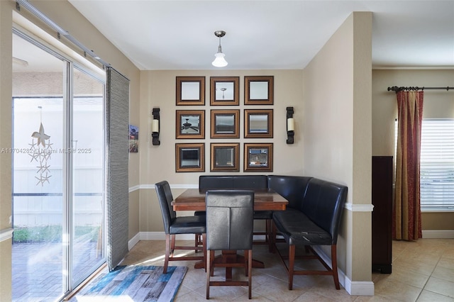 dining space featuring light tile patterned floors and plenty of natural light