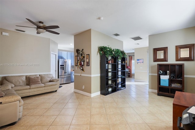 living room with ceiling fan and light tile patterned flooring