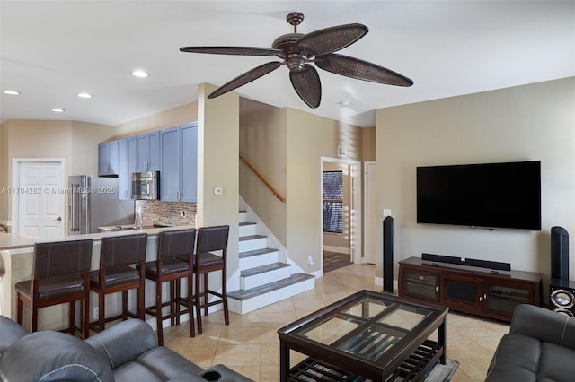 tiled living room with ceiling fan