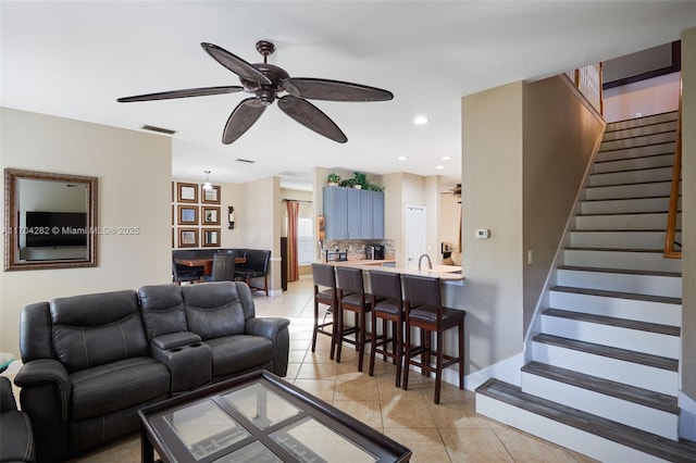 tiled living room with ceiling fan