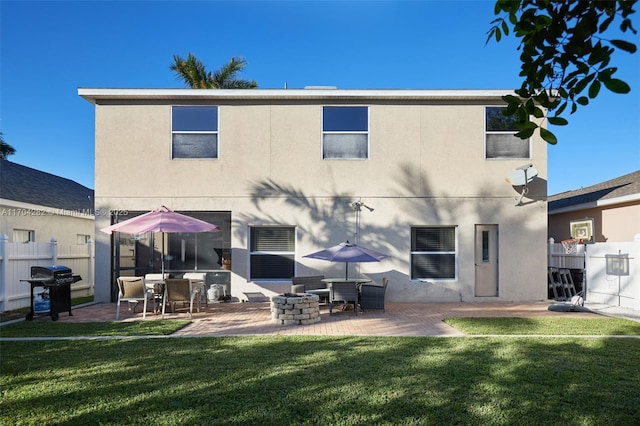 rear view of property featuring a patio and a lawn