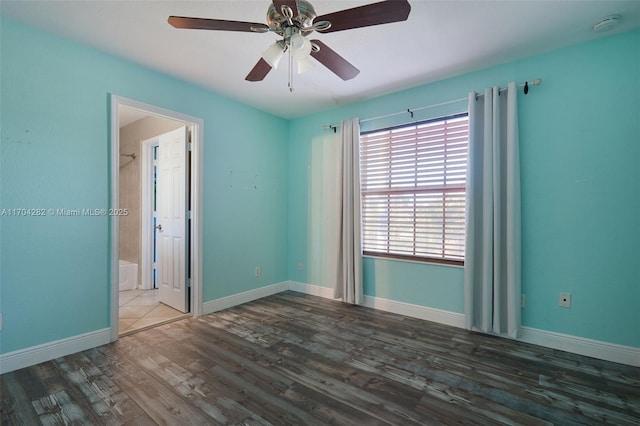 spare room with hardwood / wood-style flooring and ceiling fan