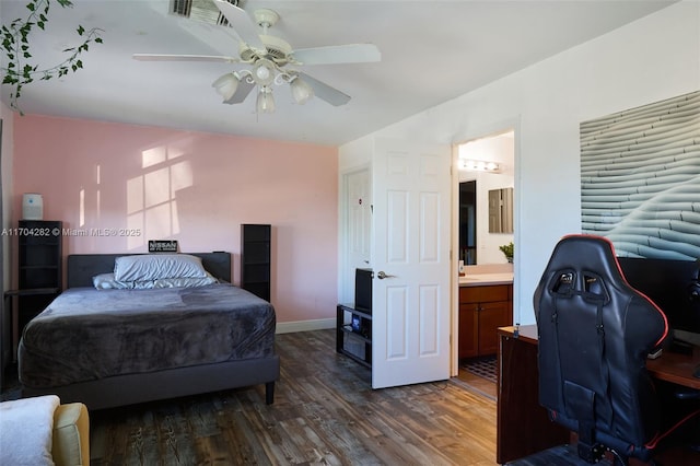 bedroom featuring ceiling fan, ensuite bath, and dark hardwood / wood-style flooring