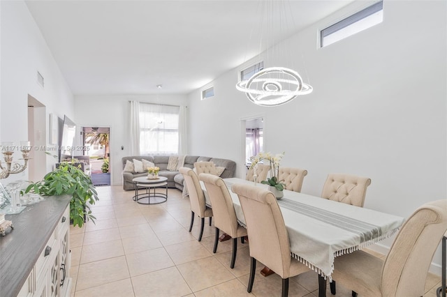 dining room with lofted ceiling, light tile patterned flooring, and visible vents