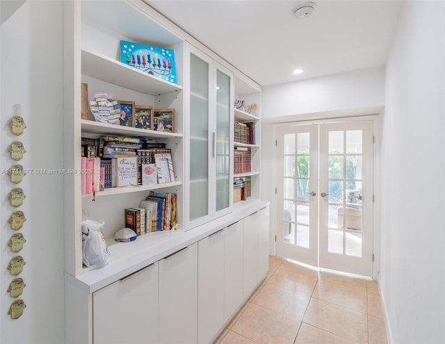 doorway to outside featuring recessed lighting, french doors, and light tile patterned floors