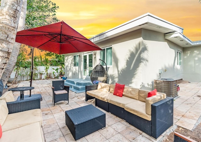 view of patio / terrace with fence, an outdoor hangout area, and french doors