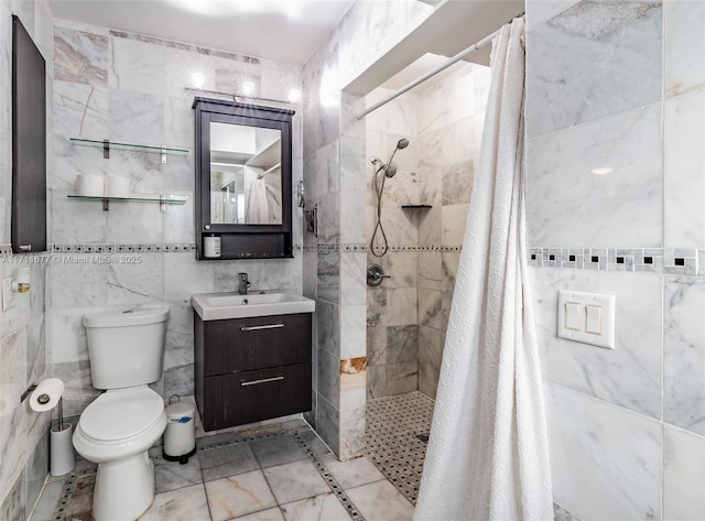 full bath featuring tile walls, a tile shower, vanity, and toilet