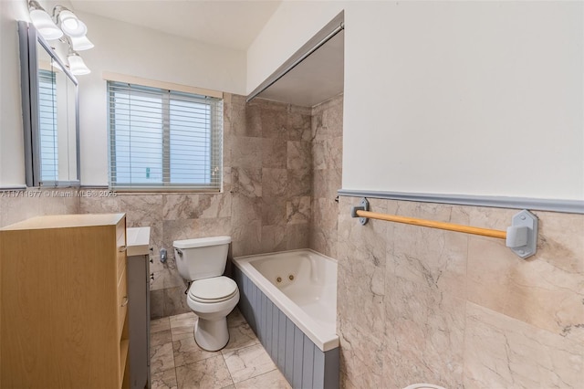 full bath with toilet, vanity, tile walls, marble finish floor, and a tub with jets