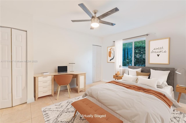 bedroom with multiple closets, ceiling fan, baseboards, and light tile patterned floors