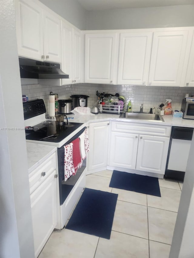 kitchen with white cabinets, white appliances, sink, and tasteful backsplash