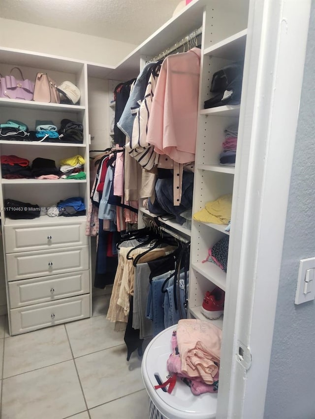 walk in closet featuring light tile patterned flooring