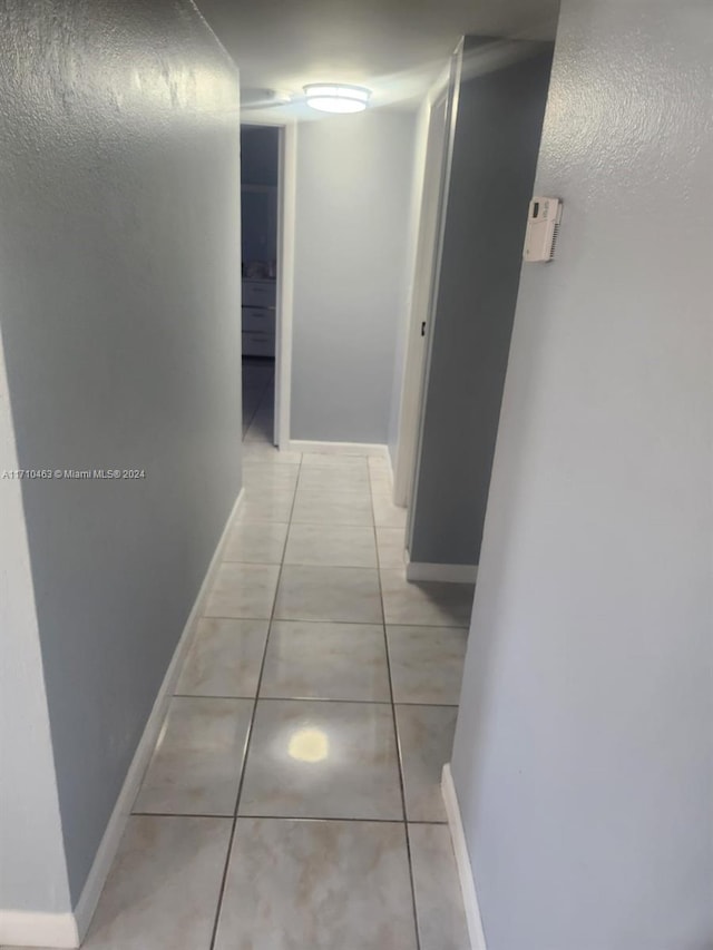 hallway with light tile patterned floors