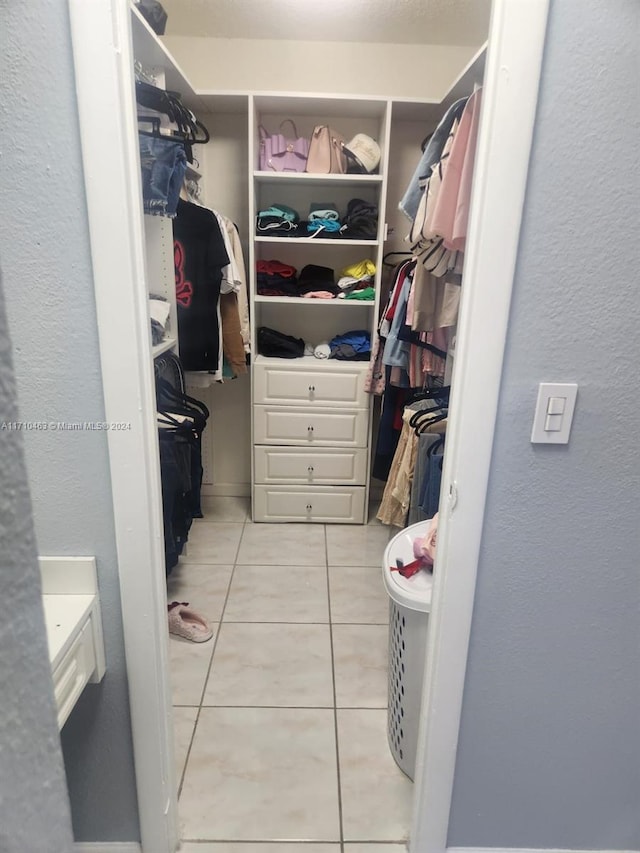 spacious closet with light tile patterned flooring