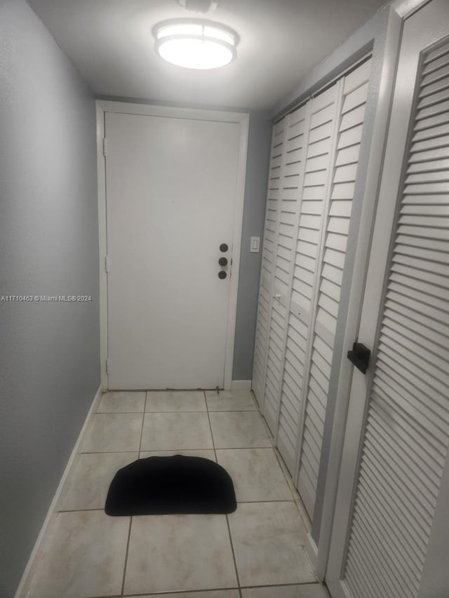 hallway with light tile patterned floors