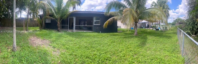 view of yard featuring a sunroom