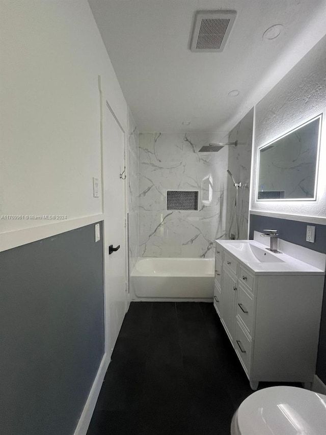 full bathroom featuring vanity, toilet, and tiled shower / bath combo