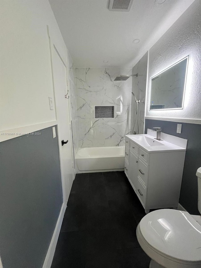 full bathroom with vanity, toilet, and tiled shower / bath combo