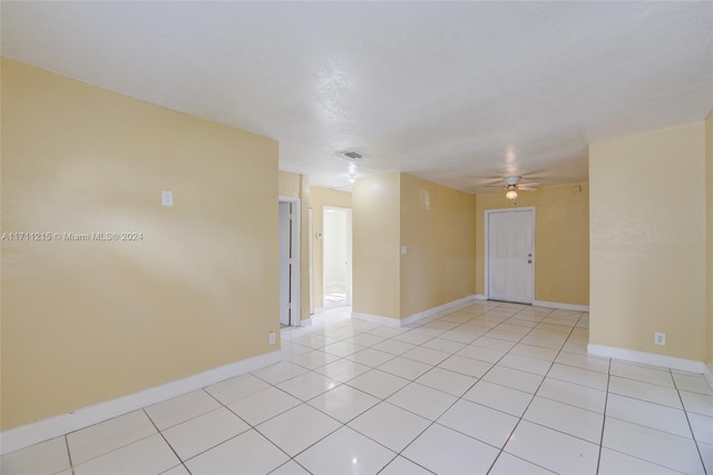 empty room featuring light tile patterned floors and ceiling fan