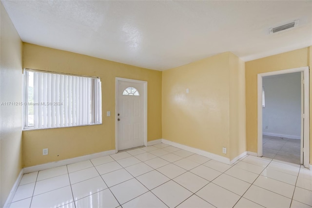 entrance foyer with light tile patterned floors and a textured ceiling