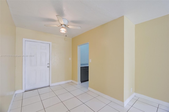 unfurnished room with light tile patterned floors and ceiling fan