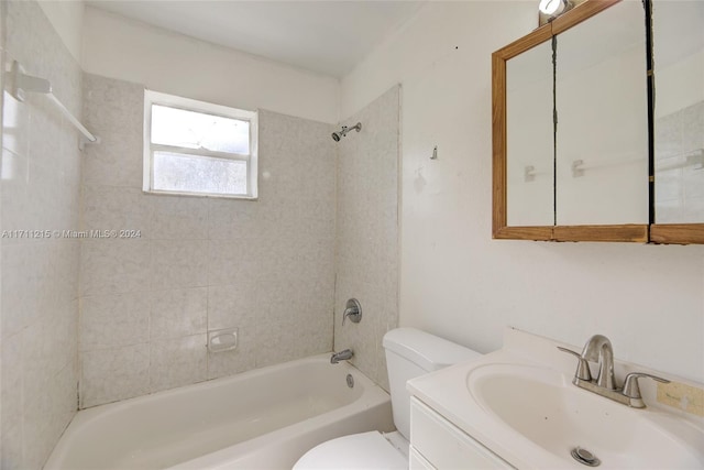 full bathroom with toilet, vanity, and tiled shower / bath