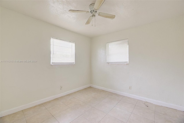 unfurnished room with ceiling fan and light tile patterned floors