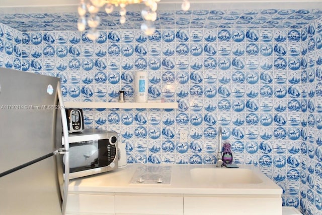 kitchen featuring white cabinetry, sink, and appliances with stainless steel finishes