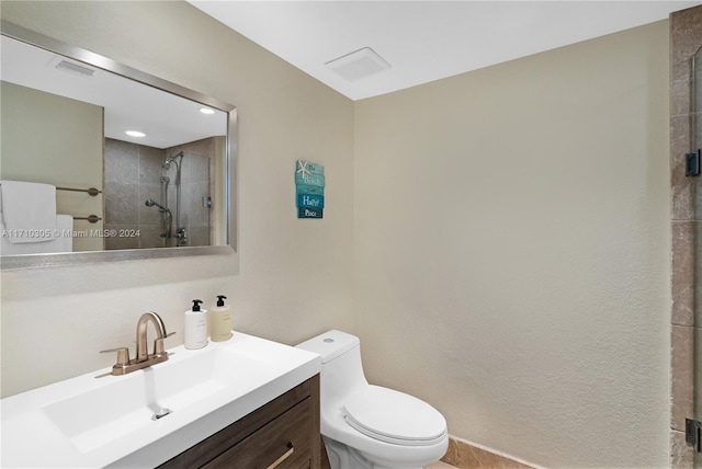 bathroom with vanity, an enclosed shower, and toilet