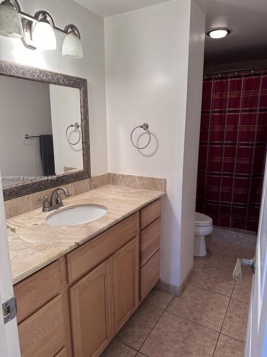 bathroom with tile patterned floors, vanity, and toilet