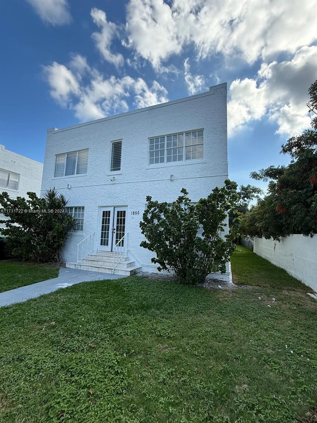 view of front of home featuring french doors and a front yard