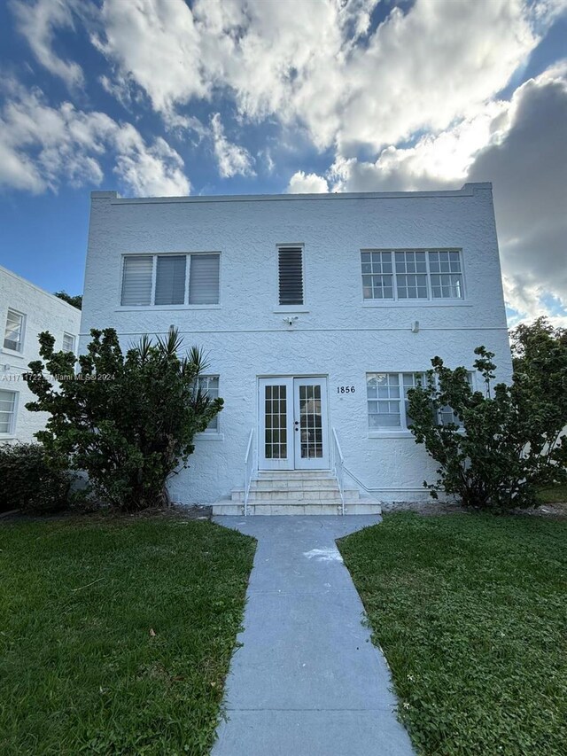 view of front of home featuring a front yard and french doors