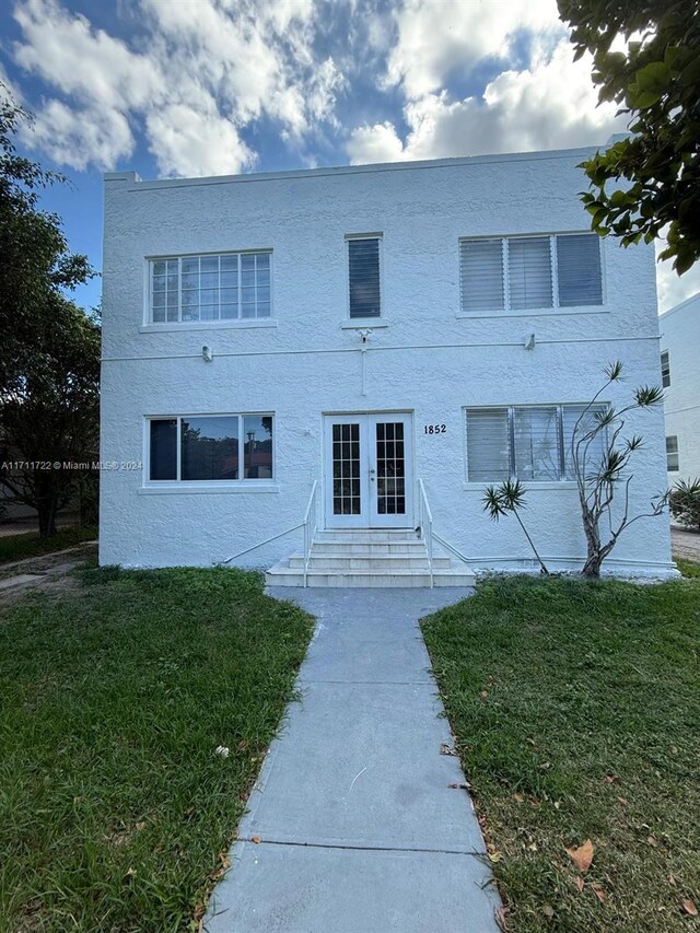 view of front facade with french doors and a front yard