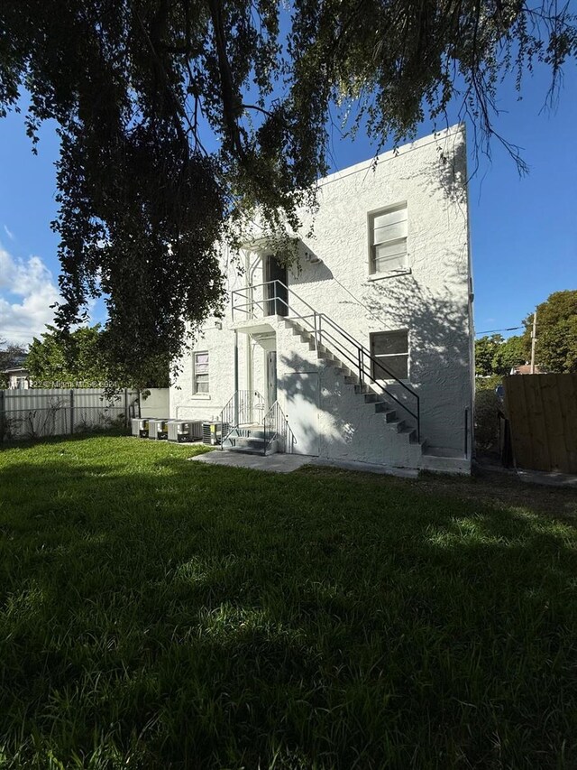 rear view of property with a lawn