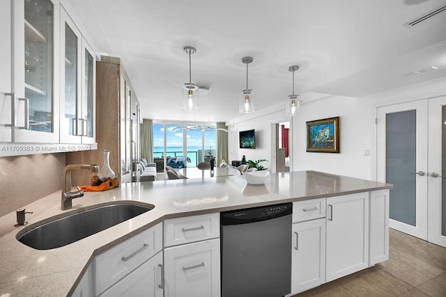 kitchen featuring white cabinetry, dishwasher, hanging light fixtures, and sink