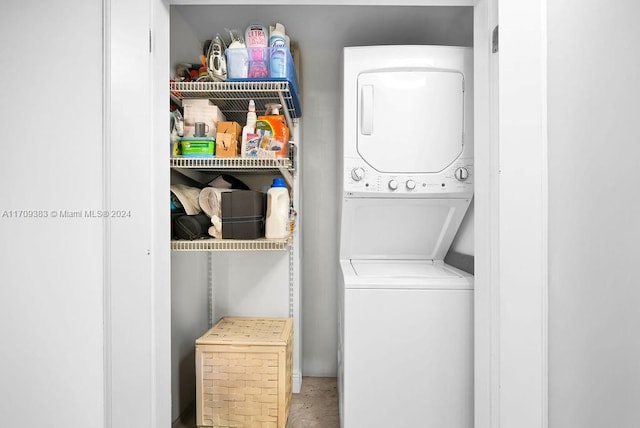 clothes washing area with stacked washer and clothes dryer