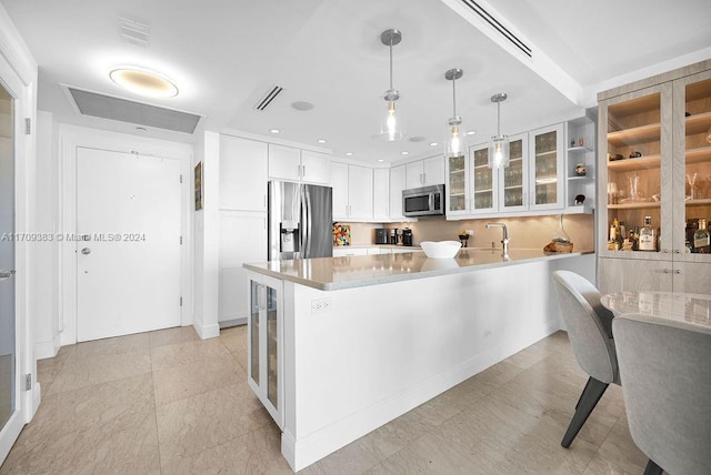 kitchen featuring wine cooler, white cabinetry, pendant lighting, and stainless steel appliances