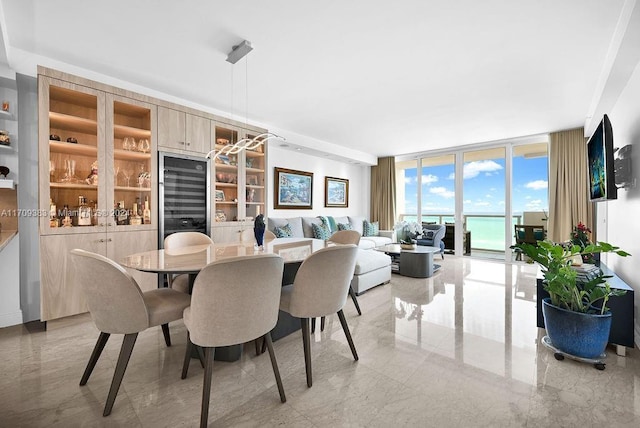 dining room with a wall of windows and beverage cooler