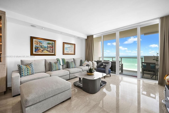 living room with plenty of natural light, expansive windows, and a water view