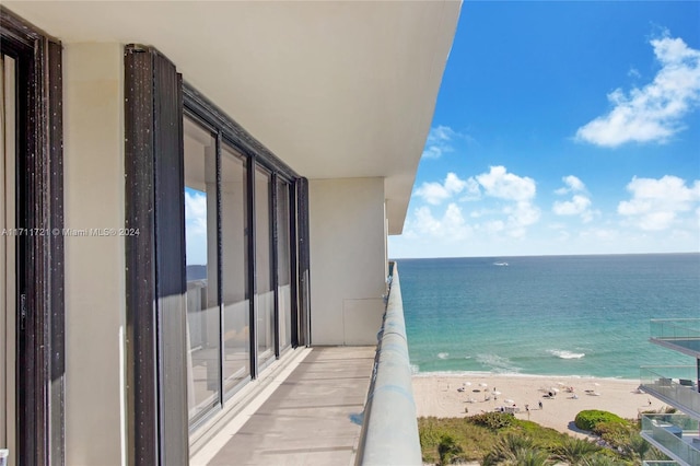 balcony with a view of the beach and a water view