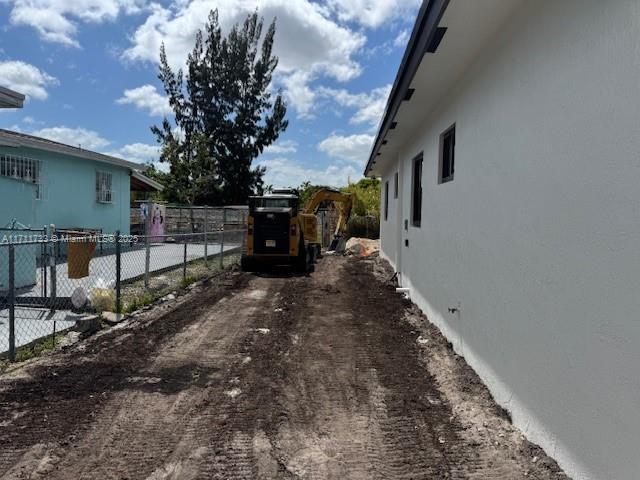 view of property exterior featuring fence and stucco siding
