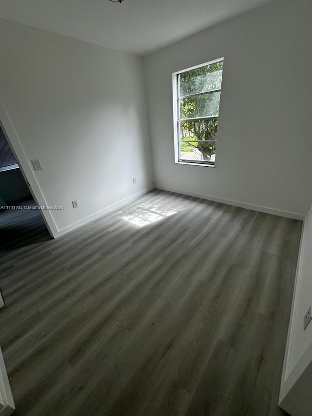 spare room featuring dark hardwood / wood-style floors