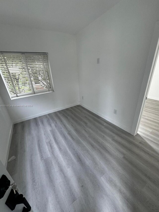 spare room with hardwood / wood-style floors