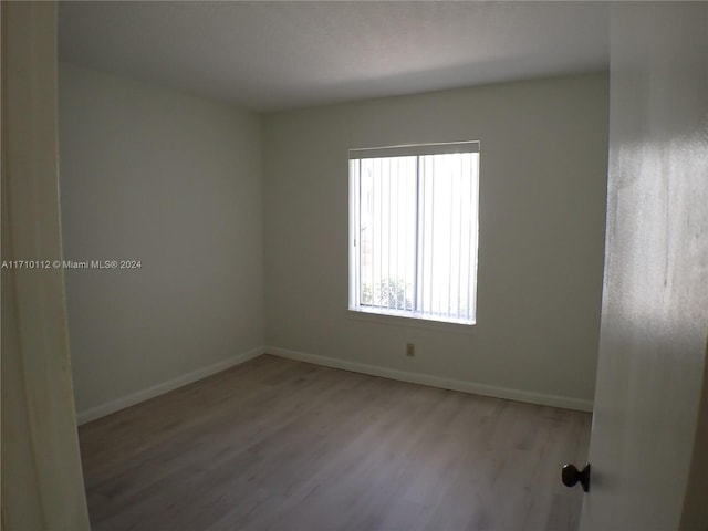 unfurnished room with light hardwood / wood-style floors