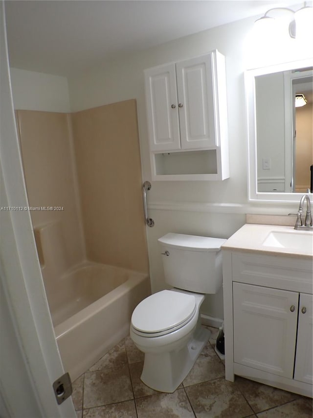 full bathroom with bathing tub / shower combination, tile patterned flooring, vanity, and toilet