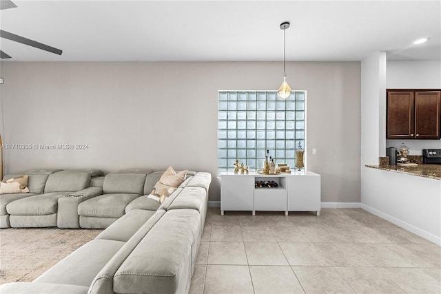 living room with ceiling fan and light tile patterned flooring