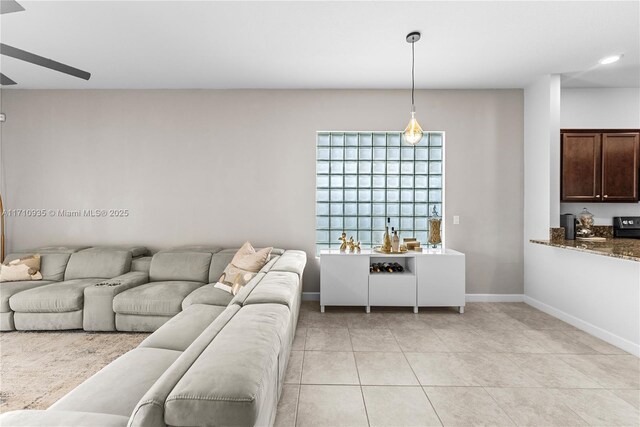 tiled living room featuring ceiling fan