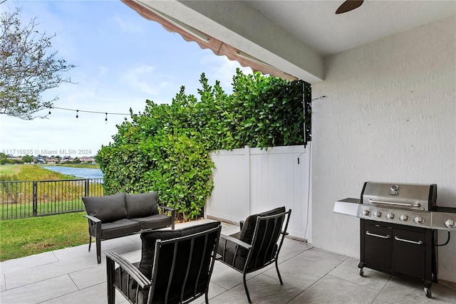 view of patio with a water view, an outdoor hangout area, and grilling area