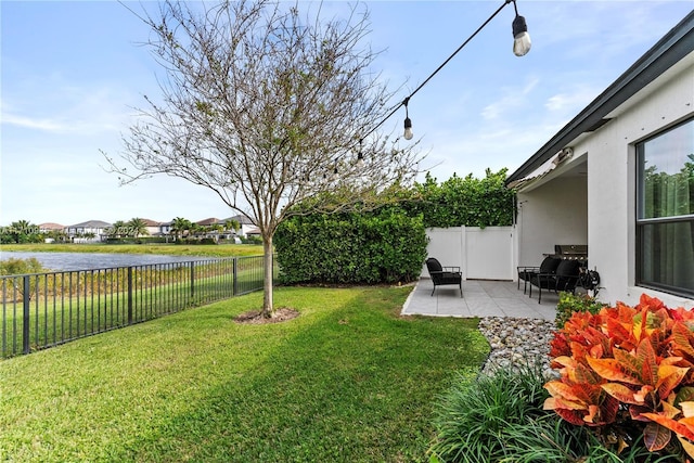 view of yard featuring a patio and a water view