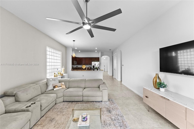 tiled living room featuring ceiling fan